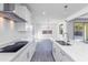 Clean, modern kitchen featuring a large island, stainless appliances, and a sleek cooktop at 17469 N 66Th Ave, Glendale, AZ 85308