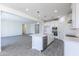 Bright kitchen open to living space with stainless appliances, white cabinetry and large island at 17469 N 66Th Ave, Glendale, AZ 85308