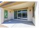 Covered patio with sliding glass doors, extending the living space outdoors for relaxation and entertainment at 17469 N 66Th Ave, Glendale, AZ 85308