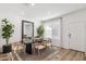 Bright dining area with large window and hardwood floors at 17724 W Sanna St, Waddell, AZ 85355