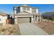 Two-story house with red door, gray garage door, and landscaping at 17724 W Sanna St, Waddell, AZ 85355