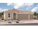 Single-story home with three-car garage and desert landscaping at 18228 W Hess St, Goodyear, AZ 85338