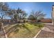 Landscaped backyard with grassy area and brick walkway at 18487 N 111Th Dr, Surprise, AZ 85378