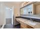 Updated bathroom with granite countertop vanity and large mirror at 18487 N 111Th Dr, Surprise, AZ 85378