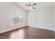 Spacious bedroom with dark brown tile flooring and ceiling fan at 18487 N 111Th Dr, Surprise, AZ 85378