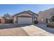 Single-story home with attached garage and landscaping at 18487 N 111Th Dr, Surprise, AZ 85378