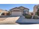 Charming single-story home with a two-car garage and well-manicured landscaping at 18487 N 111Th Dr, Surprise, AZ 85378