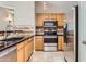 Well-equipped kitchen with ample cabinetry and a breakfast bar at 18487 N 111Th Dr, Surprise, AZ 85378