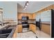 Well-equipped kitchen with stainless steel appliances and wood cabinetry at 18487 N 111Th Dr, Surprise, AZ 85378