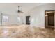 Living room with vaulted ceiling, tile flooring, and a ceiling fan at 18487 N 111Th Dr, Surprise, AZ 85378