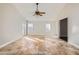 Living room with vaulted ceiling, tile flooring, and a ceiling fan at 18487 N 111Th Dr, Surprise, AZ 85378