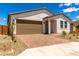 Well-maintained home featuring a two-car garage, paved driveway, and desert landscaping at 18556 E Dario Rd, Gold Canyon, AZ 85118