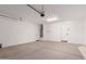Spacious garage featuring a concrete floor, white paint, multiple doors, and overhead lighting at 18556 E Dario Rd, Gold Canyon, AZ 85118