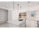 Open kitchen featuring an island with bar seating and views into the living room at 18556 E Dario Rd, Gold Canyon, AZ 85118