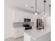 Updated kitchen with stainless steel appliances, white cabinetry, and modern lighting at 18556 E Dario Rd, Gold Canyon, AZ 85118