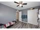 Bedroom features ceiling fan, gray walls, and luxury vinyl plank flooring at 1905 W 2Nd St, Mesa, AZ 85201