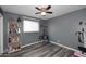 Bedroom features ceiling fan, gray walls, and luxury vinyl plank flooring at 1905 W 2Nd St, Mesa, AZ 85201