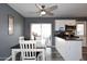 Eat-in kitchen features white cabinets, stainless appliances, gray walls and luxury vinyl plank flooring at 1905 W 2Nd St, Mesa, AZ 85201