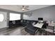 Comfortable living room with gray walls, luxury vinyl flooring, a ceiling fan, and a large sectional sofa at 1905 W 2Nd St, Mesa, AZ 85201