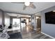 Open concept living room with gray walls, luxury vinyl flooring, and a large sectional sofa at 1905 W 2Nd St, Mesa, AZ 85201