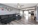 Open concept living room leading into a kitchen with stainless steel appliances and white cabinets at 1905 W 2Nd St, Mesa, AZ 85201