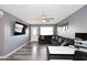 Comfortable living room with gray walls, luxury vinyl flooring, a ceiling fan, and television at 1905 W 2Nd St, Mesa, AZ 85201