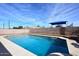 Backyard pool surrounded by a brick wall, a play area, and a shed at 1905 W 2Nd St, Mesa, AZ 85201