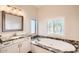 Bathroom boasts a large soaking tub and granite countertops at 19530 E Via Del Oro --, Queen Creek, AZ 85142