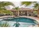 Relaxing kidney-shaped pool with palm trees at 19530 E Via Del Oro --, Queen Creek, AZ 85142