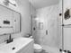 Contemporary bathroom features a glass shower with white marble tiling, matte black hardware, and modern fixtures at 19531 N 69Th Ave, Glendale, AZ 85308