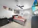 This bedroom features ceiling fan, modern lighting, wood grain vinyl flooring, posters and a wall-mounted TV at 19531 N 69Th Ave, Glendale, AZ 85308