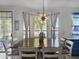 Bright and airy dining area featuring a modern light fixture and outdoor access at 19531 N 69Th Ave, Glendale, AZ 85308