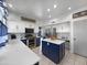 Well-lit kitchen featuring a central island, modern stainless steel appliances, and white upper cabinets at 19531 N 69Th Ave, Glendale, AZ 85308