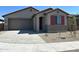 Single-story home with gray exterior, red shutters, and a two-car garage at 20863 N 223Rd Ave, Surprise, AZ 85387