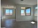 Bright living room with tile flooring and sliding glass doors leading to a patio at 20863 N 223Rd Ave, Surprise, AZ 85387