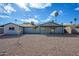 Spacious backyard with gravel, a covered patio, and mature trees at 2112 E Fremont E Dr, Tempe, AZ 85282