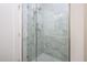 Shower with glass enclosure and marble tile at 2112 E Fremont E Dr, Tempe, AZ 85282