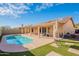 Inviting backyard pool, patio, and artificial turf create an outdoor oasis for relaxation and recreation at 2217 E Devon Ct, Gilbert, AZ 85296