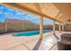 Relaxing view of the backyard pool from under the covered patio creates a serene outdoor escape at 2217 E Devon Ct, Gilbert, AZ 85296