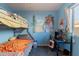 Cozy bedroom with bunk beds, desk, and vibrant wall art at 2217 E Devon Ct, Gilbert, AZ 85296