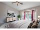 Comfortable bedroom with a ceiling fan, soft carpet, and sliding glass doors leading to an outside view at 2217 E Devon Ct, Gilbert, AZ 85296