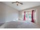 Empty bedroom with a ceiling fan, soft carpet, and sliding glass doors leading to an outside view at 2217 E Devon Ct, Gilbert, AZ 85296