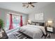 Cozy bedroom with a ceiling fan, stylish furniture, and sliding glass doors leading to the backyard at 2217 E Devon Ct, Gilbert, AZ 85296