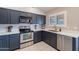 Kitchen with stainless steel appliances and dark gray cabinets at 2217 E Devon Ct, Gilbert, AZ 85296