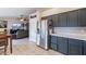 Kitchen with stainless steel refrigerator and dark gray cabinets at 2217 E Devon Ct, Gilbert, AZ 85296