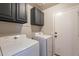 Laundry room with washer, dryer, and ample cabinet space at 2217 E Devon Ct, Gilbert, AZ 85296