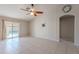 Bright living area with tile flooring, ceiling fan, sliding glass doors, and backyard pool access at 2217 E Devon Ct, Gilbert, AZ 85296