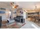 Open living room and kitchen with gray sectional sofa and dining area at 2217 E Devon Ct, Gilbert, AZ 85296