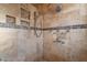 Spa-like shower with multiple shower heads and built-in shelves at 2217 E Devon Ct, Gilbert, AZ 85296