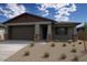 Charming single-story home featuring a two-car garage and low-maintenance desert landscaping at 22645 W Irma Ln, Surprise, AZ 85387